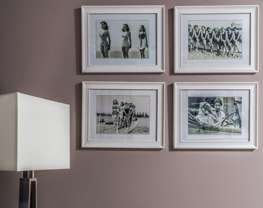 Chic interior wall decor featuring vintage black and white framed nostalgic photos.